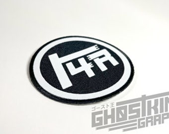 May include: Black and white embroidered patch with the text "4A" in a circle. The patch is made of fabric and has a white border.
