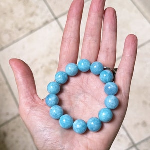 K&ouml;nnte beinhalten: Ein hellblaues Edelstein-Armband mit runden Perlen. Das Armband besteht aus Aquamarin-Steinen.