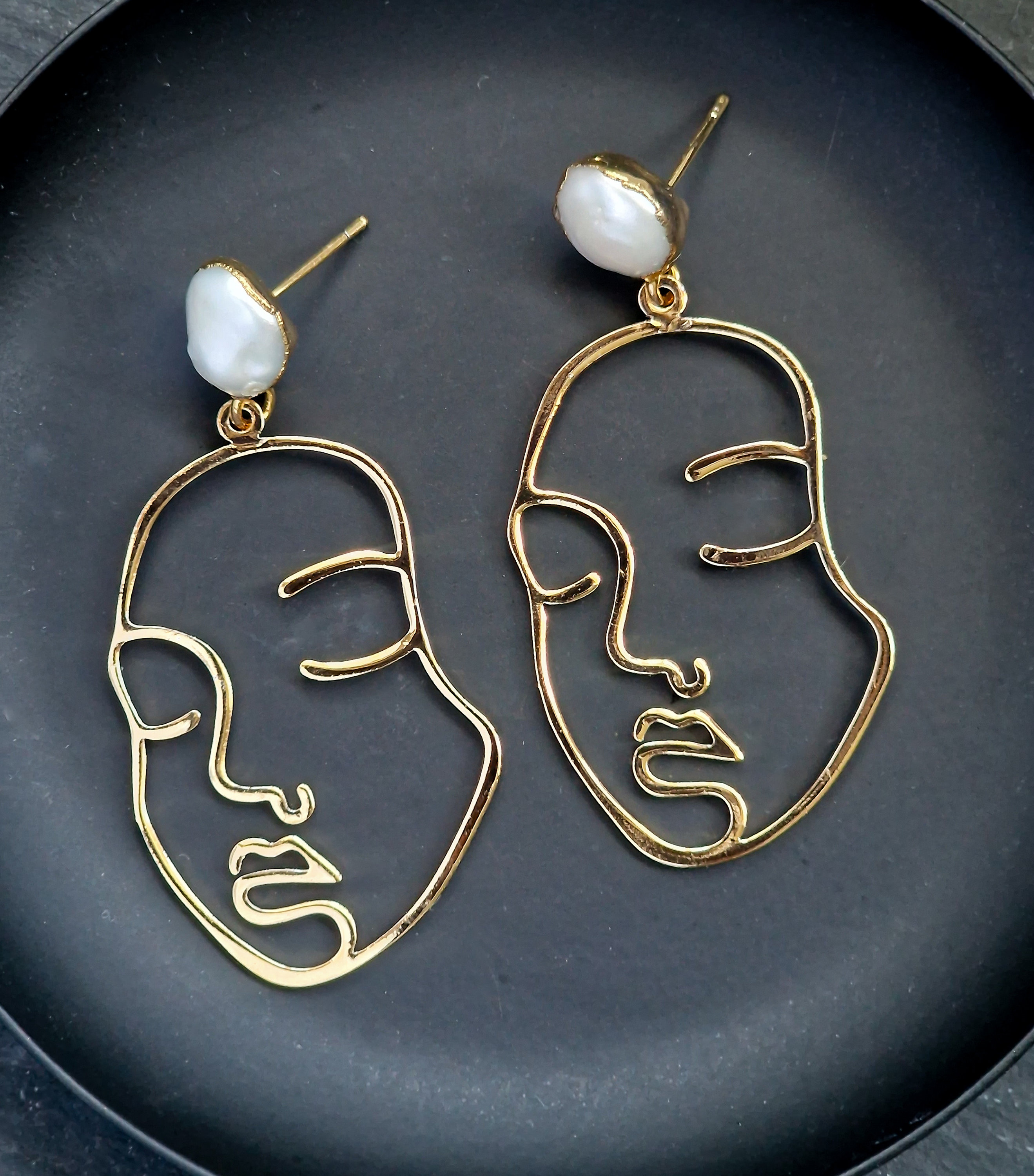 Art face earrings deals