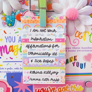 May include: A colorful affirmation card with the text "I Am Not Your Inspiration: Affirmations for Chronically Ill & Sick Babes" by Karina Killjoy, Femme Filth Press.
