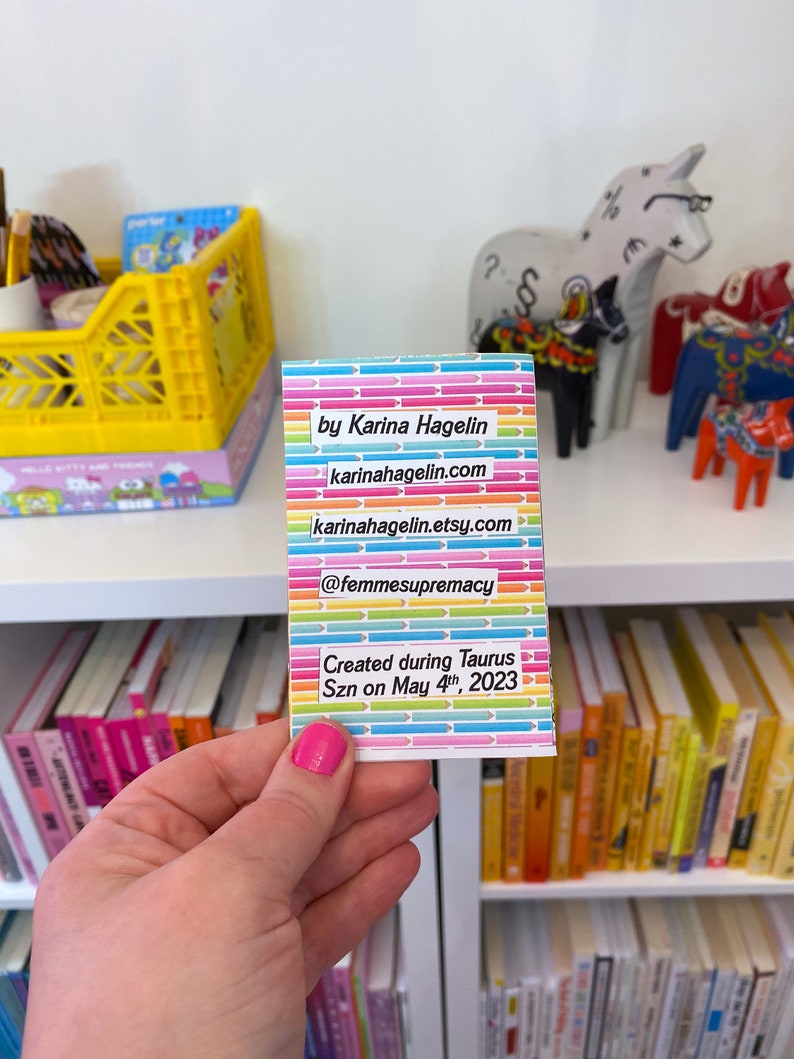 May include: A rainbow-colored card with the text "by Karina Hagelin", "karinahagelin.com", "karinahagelin.etsy.com", "@femmesupremacy", "Created during Taurus Szn on May 4th, 2023".
