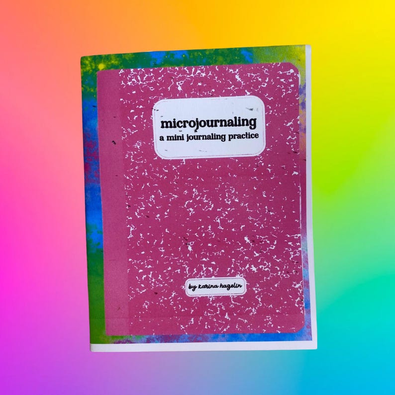 May include: A composition notebook with a pink cover and white speckles. The notebook has the text "microjournaling a mini journaling practice" in a white rectangle. The author's name, Karina Hazelin, is at the bottom.