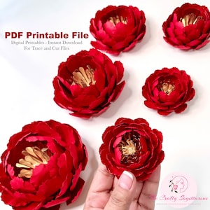 May include: Five red paper peonies with gold centers. The peonies are arranged on a white surface. The text "PDF Printable File" is at the top of the image. The text "Digital Printables - Instant Download" is below the first line of text. The text "For Trace and Cut Files" is below the second line of text. The text "Crafty Sagittarius" is at the bottom of the image. The text "PREMIUM PAPER FLOWER TEMPLATES" is below the first line of text.