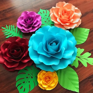 May include: A set of six paper flowers in various colors, including red, pink, orange, blue, and yellow. The flowers are surrounded by green paper leaves.
