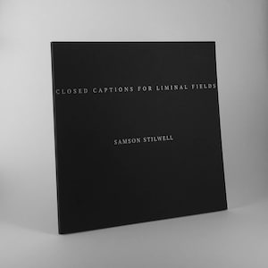 May include: Black book with the title "Closed Captions for Liminal Fields" and the author's name "Samson Stilwell" printed in white.
