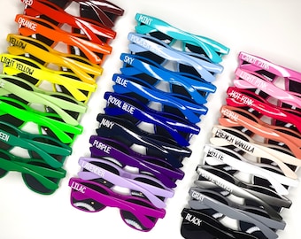 May include: A set of 20 colorful sunglasses with different colored frames and black lenses. Each pair has a different color name written on the frame, such as "Mint", "Orange", "Purple", "Lime", "Black", and "Coral".