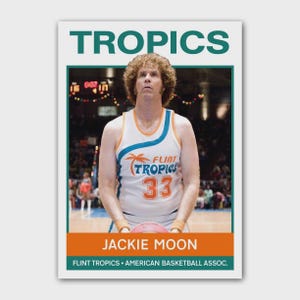 May include: A trading card featuring a man in a white and orange basketball jersey with the text "Flint Tropics 33". The card has the word "TROPICS" at the top and "JACKIE MOON" at the bottom. The card is framed in green.