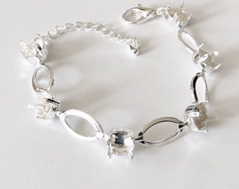 May include: Silver bracelet with oval links and settings for stones. The bracelet has a lobster clasp closure.
