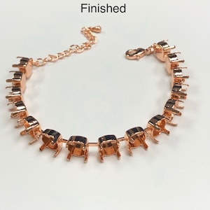 May include: A rose gold bracelet with a chain and clasp. The bracelet is made of metal settings that are designed to hold gemstones.