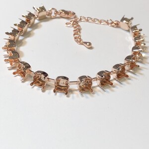 May include: A rose gold bracelet with a chain and multiple settings for stones. The bracelet is made of metal and has a clasp.