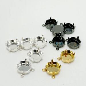 May include: A collection of jewelry-making components, including several round bezel settings in silver, gold, and gunmetal finishes. These settings have prongs for securing stones and loops for attaching to other jewelry pieces.