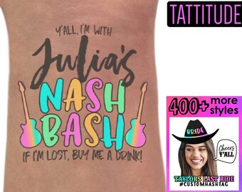 May include: A temporary tattoo with the text "Y'all, I'm with Julia's Nash Bash" in colorful letters with guitar graphics. The text "If I'm lost, buy me a drink!" is below the main text. The tattoo is on a person's arm. A separate image shows a woman wearing a cowboy hat with the word "Bride" on it. The text "400+ more styles" is in the image.