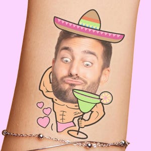 May include: A temporary tattoo featuring a cartoon image of a man wearing a sombrero and holding a margarita. The man has a surprised expression and is surrounded by hearts. The tattoo is on a person's arm.