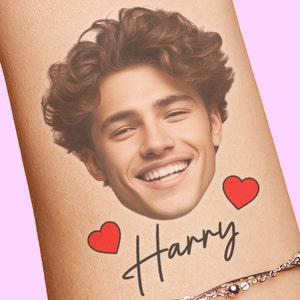 May include: A temporary tattoo featuring a man's face, the name "Harry" written in cursive, and two red hearts.