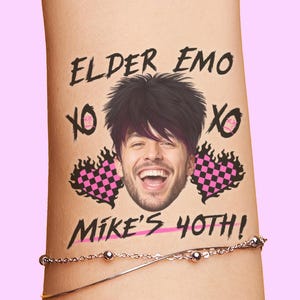 May include: A temporary tattoo design featuring a smiling man with black hair and purple highlights. The text reads "ELDER EMO" and "MIKE'S 40TH!" with "XO" and pink and black checkered hearts.