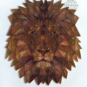 May include: A lion's face created with string art. The lion's mane is made of brown, tan, and gold string, and the face is made of brown and black string. The string is wrapped around nails that are hammered into a wooden board. The background is white.