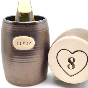 May include: Two ceramic bottle coolers, one with a heart and the number 8, the other with the date 3.17.17.
