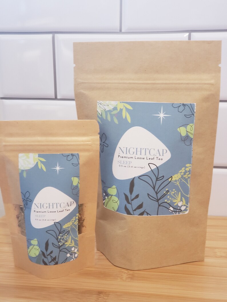 May include: Two brown paper bags with a zipper closure. The bags contain loose leaf tea. The larger bag has a label that says "NIGHTCAP Premium Loose Leaf Tea SLEEP 0.5 oz (3-6 servings)". The smaller bag has a label that says "NIGHTCAP Premium Loose Leaf Tea SLEEP 0.5 oz (3-6 servings)".