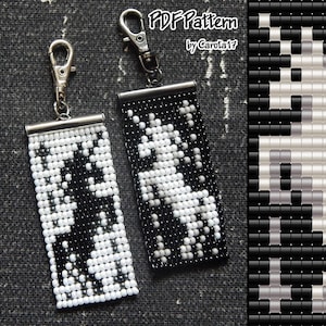 May include: Two beaded keychains with a black and white pattern. The keychains have a rectangular shape with a silver-coloured metal clasp and a metal bar at the top. The pattern appears to be a stylized design. The text "PDF Pattern by Carola17" is visible.