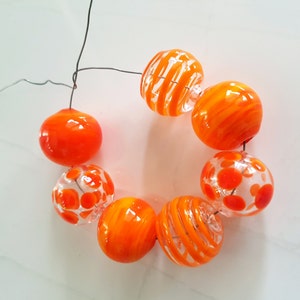 7pc orange hollow glass beads, lampwork, blown glass, transparent