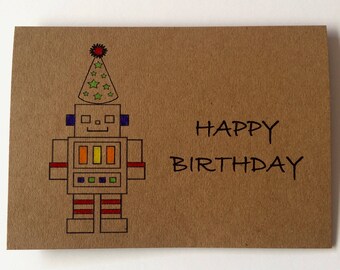 Puede incluir: Tarjeta de cumpleaños marrón con una ilustración de robot colorido con un gorro de fiesta. El robot está decorado con detalles rojos, amarillos, azules y verdes. El texto "HAPPY BIRTHDAY" está escrito en negro.