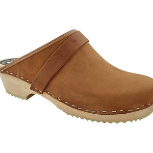 May include: Brown leather clog with a wooden sole and a strap across the top.