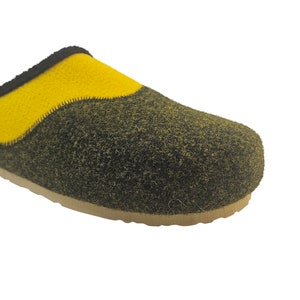 May include: Yellow and black wool house slippers with a closed toe and an open back. The slippers have a textured sole.