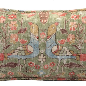 May include: A rectangular throw pillow featuring a sage green background with a repeating pattern of two mirrored birds facing each other. The design includes floral motifs in shades of coral, yellow, and blue, with blue textured vertical elements.