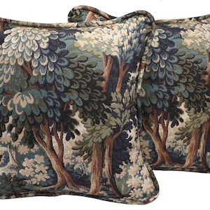 May include: Two square throw pillows with a forest scene design. The pillows feature a tapestry-like pattern with trees in shades of green, brown, and blue. The pillows have a decorative border and are likely used for home decor.