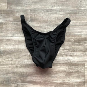 May include: Black underwear with a low rise and a wide waistband.