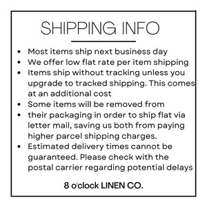 May include: White rectangular sign with the text "SHIPPING INFO" at the top. Below are bullet points detailing shipping policies, including flat rates and potential removal of packaging. The brand name "8 o'clock LINEN CO." is at the bottom.