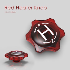 Op de afbeelding: Rode plastic knop met een witte "H" en pijlen die de richtingen "A" en "Z" aangeven. De knop heeft een zespuntige stervorm.