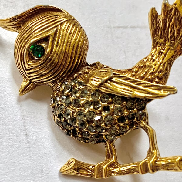 Gold bird with green rhinestone eyes brooch pin