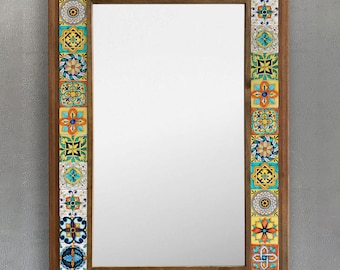 May include: Rectangular mirror with a wooden frame. The frame is decorated with colorful, patterned tiles in shades of blue, yellow, orange, and turquoise. The mirror's reflective surface is clear.