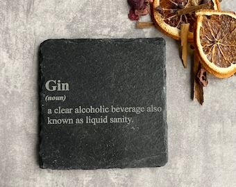 May include: Black slate coaster with the word "Gin" and the definition "a clear alcoholic beverage also known as liquid sanity."