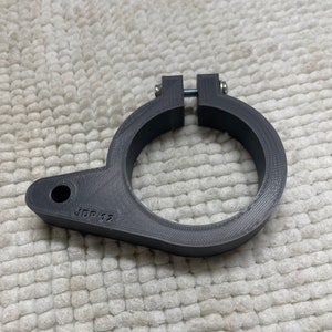 May include: A gray 3D printed clamp with a screw and the text "JDP 12" on the side.