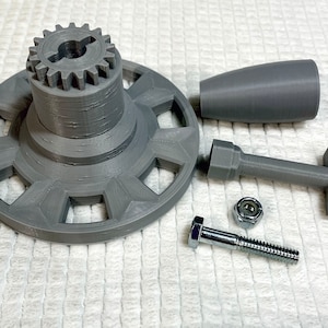 May include: A 3D printed gray plastic gear mechanism with a round base, a handle, a gear, a bolt, and a nut.