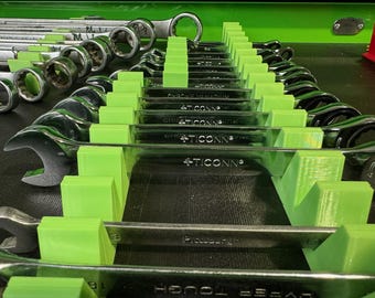 May include: A set of wrenches organized in a toolbox with green dividers. The wrenches are labeled with the brand name "TICCONN" and the material "CHROME VANADIUM".