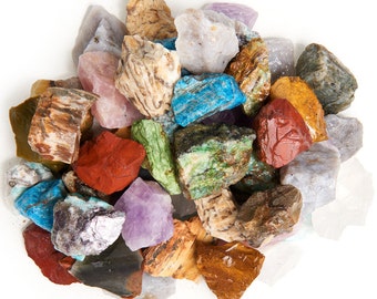 May include: A collection of colorful, rough-cut gemstones, including amethyst, turquoise, jasper, and agate. The stones are various sizes and shapes, and some have a natural, polished finish.