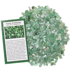 May include: Green Aventurine tumbled stones, a collection of small, smooth, green stones. The stones are known as the Stone of Opportunity and are said to attract love, comfort, and harmony. The image includes a card with information about the stones.