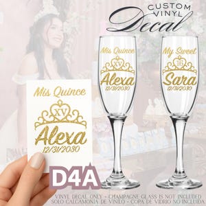 May include: Custom vinyl decal with gold text for a quincea&ntilde;era or sweet sixteen celebration. The design includes a crown, the name "Alexa" or "Sara", and the date 12/31/2030. The decal is shown on a champagne glass.
