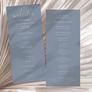 May include: A blue wedding ceremony programme with the names Emily and Jonathon, the date September 15, 2013, and the order of events for the ceremony. The programme also includes a list of the wedding party members and their roles.