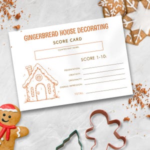 May include: A score card for gingerbread house decorating with the text "GINGERBREAD HOUSE DECORATING SCORE CARD". The card includes sections for contestant name and scores for presentation, creativity, originality, and overall impression. Gingerbread cookie cutters and a gingerbread man are also visible.