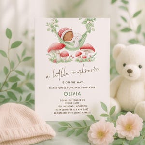 May include: Baby shower invitation with a watercolor illustration of a baby sleeping in a hammock above red mushrooms. The text reads "a little mushroom is on the way" and includes event details for Olivia.