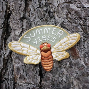 May include: An embroidered patch featuring a cicada and the text "Summer Vibes" in green and white.