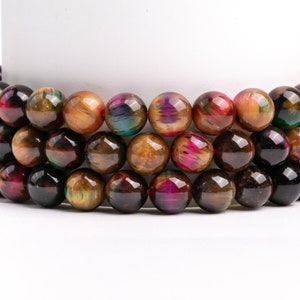 May include: A strand of iridescent tiger's eye beads in shades of brown, gold, and red. The beads are round and have a smooth, polished finish.