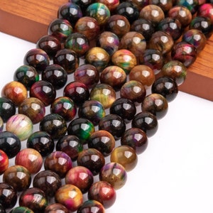 May include: A strand of round, multi-colored tiger's eye beads. The beads are a mix of brown, gold, green, and red with iridescent shimmer.