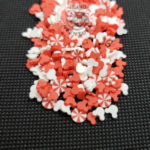 May include: Red and white sprinkles in the shape of candy canes and Mickey Mouse heads.
