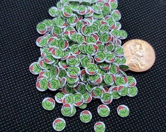 May include: A large pile of green and white round stickers with a cartoon image of the Grinch wearing a Santa hat. 
