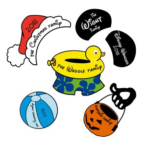 May include: Five different Christmas ornaments, each with a different theme and family name. The ornaments are a red Santa hat with "The Christmas Family 2018" written on it, a black circle with "The Wight Family" written on it, a yellow inflatable duck with "The Waddle Family" written on it, a blue beach ball with "The Summer Family 2018" written on it, and an orange pumpkin with "Pumpkin Family" written on it.